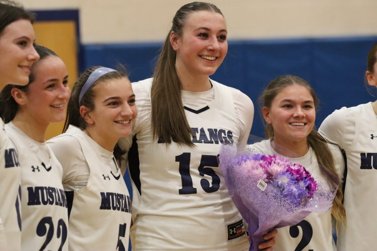 Girls Varsity Basketball posing for a group photo after #15 Anna Freeman scores her 1000th point